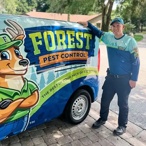 Technician standing next to Forest Pest Van - Keep pests away from your home with Forest Pest Control in FL