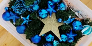 Christmas decorations packed into a plastic container for storage.